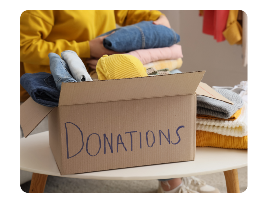 a box of clothes with donations written on it